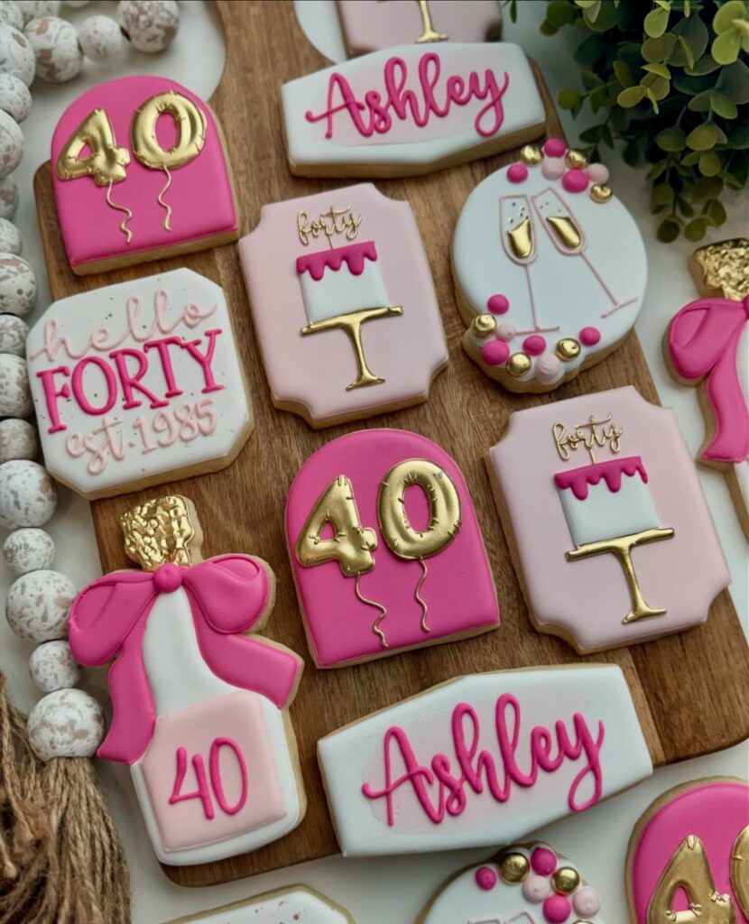 Assorted pink, white, and gold decorated sugar cookies for a 40th birthday celebration.