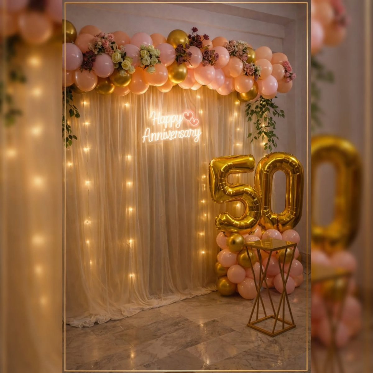 Gold number 50 balloons and peach balloon garlands decorating a white curtain backdrop.