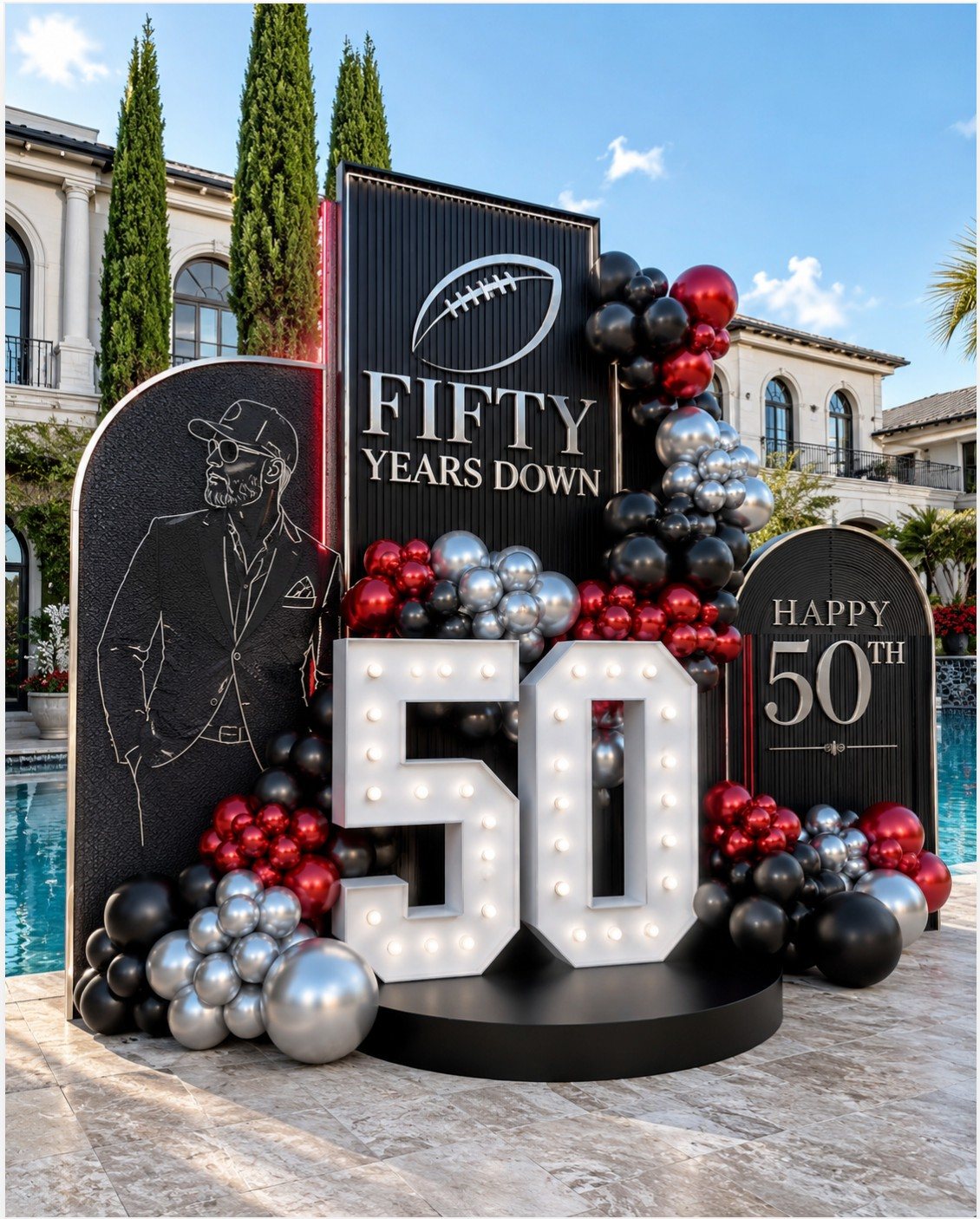 Large black and silver football-themed 50th birthday backdrop with marquee numbers and balloons.