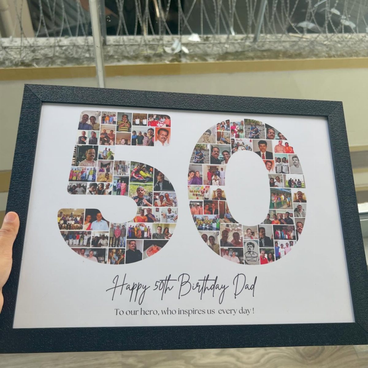 A framed photo collage in the shape of the number 50 filled with many small portraits.