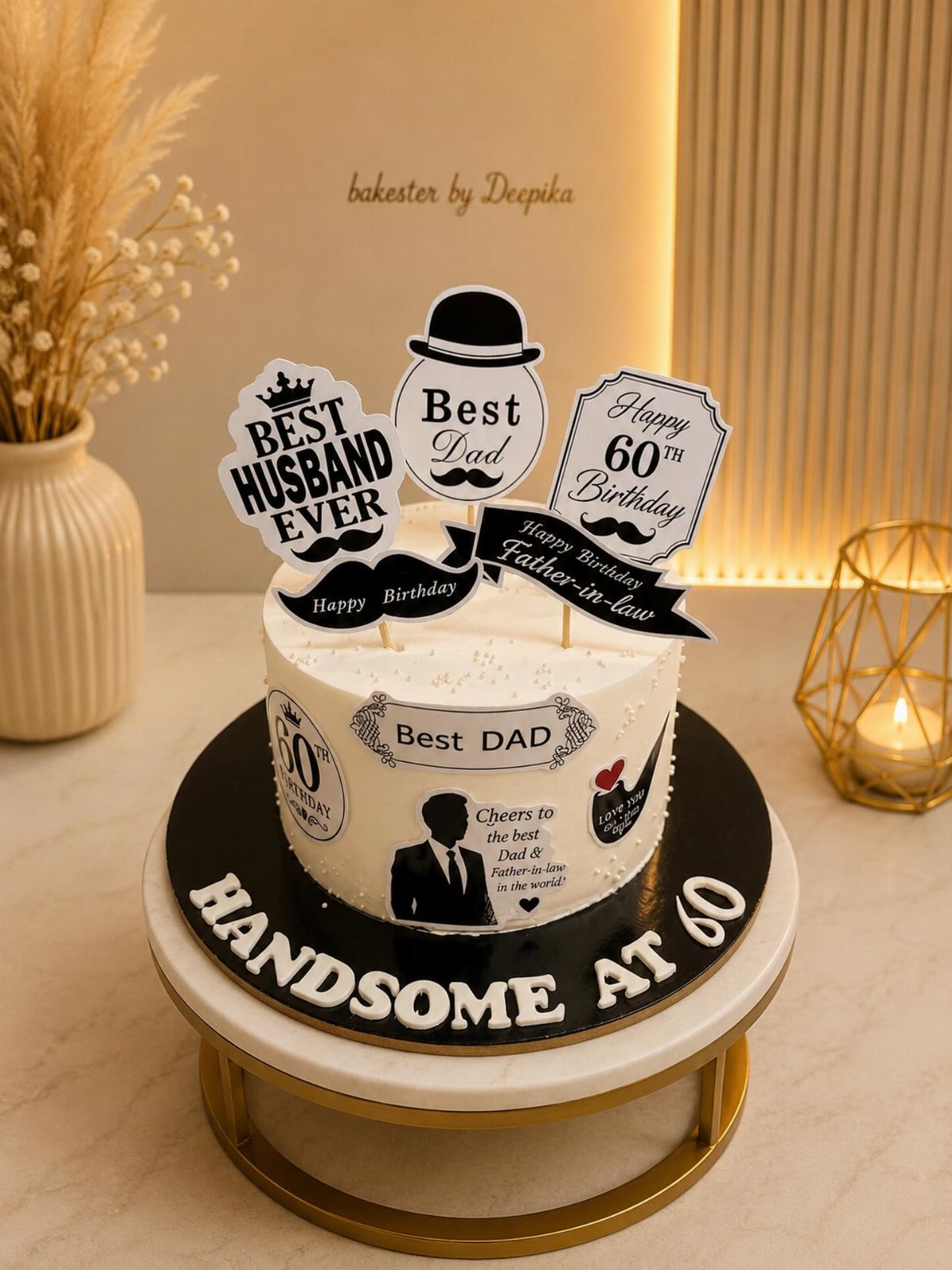 White birthday cake with black and white toppers celebrating a sixty year old father and husband.